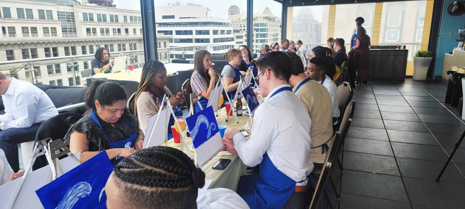A group of people participating in a paint and sip event in Washington DC.