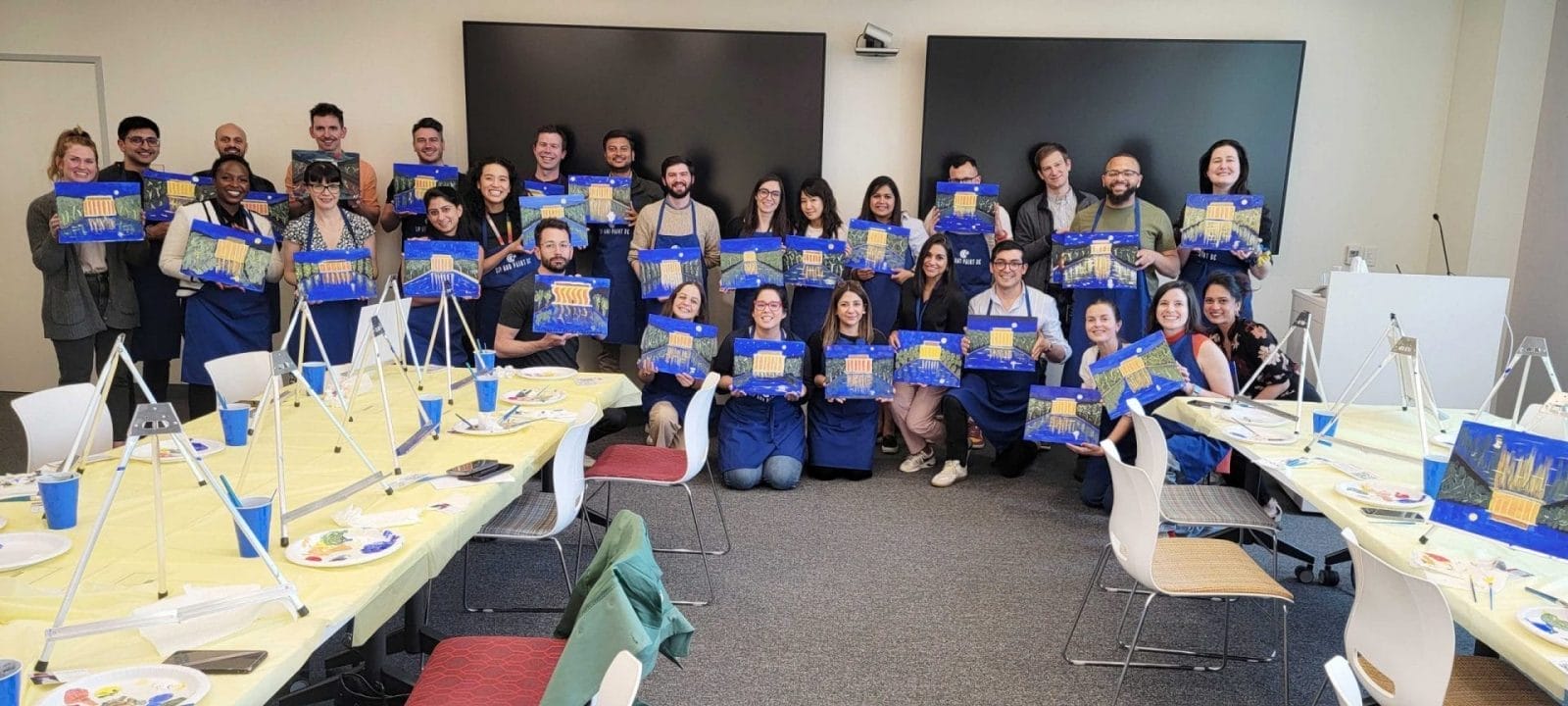 A best group posing for a picture in a paint and sip event in DC.